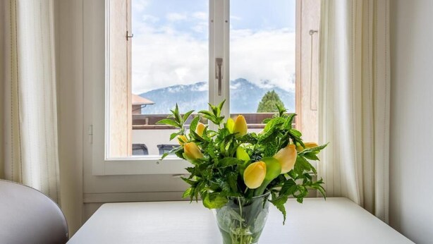 A window with a view of a mountain and a clear sky. - Hotel Sterne - Economy Triple (Beatenberg)