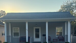 A single-story house with a front porch, a front door, and a number '109' on the wall.