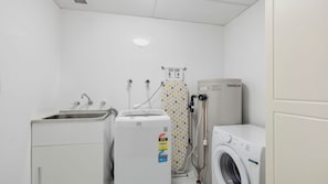 A laundry room with a washing machine, dryer, and a water heater.