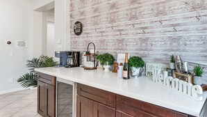 A kitchen counter with a coffee bar sign, a welcome sign, and various coffee-making equipment. - Relaxing Desert Oasis, 4 Mi to Coachella Festivals (Coachella)
