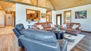 A spacious living room with leather sofas, a coffee table, and a large mirror. - Upscale A-frame Escape w/ Lake Access in Quinton! (Eufaula)