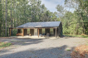 A cabin with a covered porch, a grill, and a bench. - 1 Mi to Greers Ferry Lake! Outdoor Adventure Base (Higden)