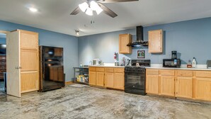 A kitchen with wooden cabinets, a refrigerator, a microwave, and a stove. - 1 Mi to Greers Ferry Lake! Outdoor Adventure Base (Higden)