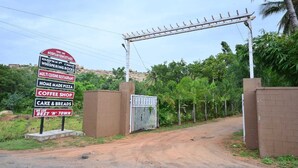 A sign listing amenities including a multi cuisine restaurant, home made pizza, coffee shop, cake & breads, and a statement claiming to be the best 'n' town. - Whispering Rocks Jungle Resort (Gangavathi)