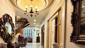 A grand hallway with a chandelier, ornate mirrors, and a staircase leading to a second floor. - Ru U Art (Richmond Hill)