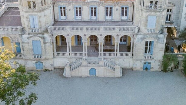 A large, historic building with a central courtyard, two towers, and a fountain. - Chateau Sainte Cecile (Saint-Thibery)