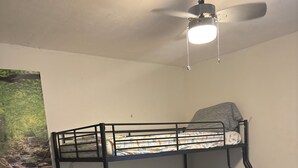 A bunk bed with a ceiling fan and a wall-mounted light fixture. - The Single Vacation Rental Dwelling (Orlando)