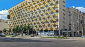 Un edificio de varios pisos con una fachada geométrica distintiva, que cuenta con numerosos balcones.