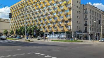A multi-story building with a distinctive geometric facade, featuring numerous balconies.