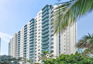 A high-rise hotel with multiple balconies and a modern architectural design.