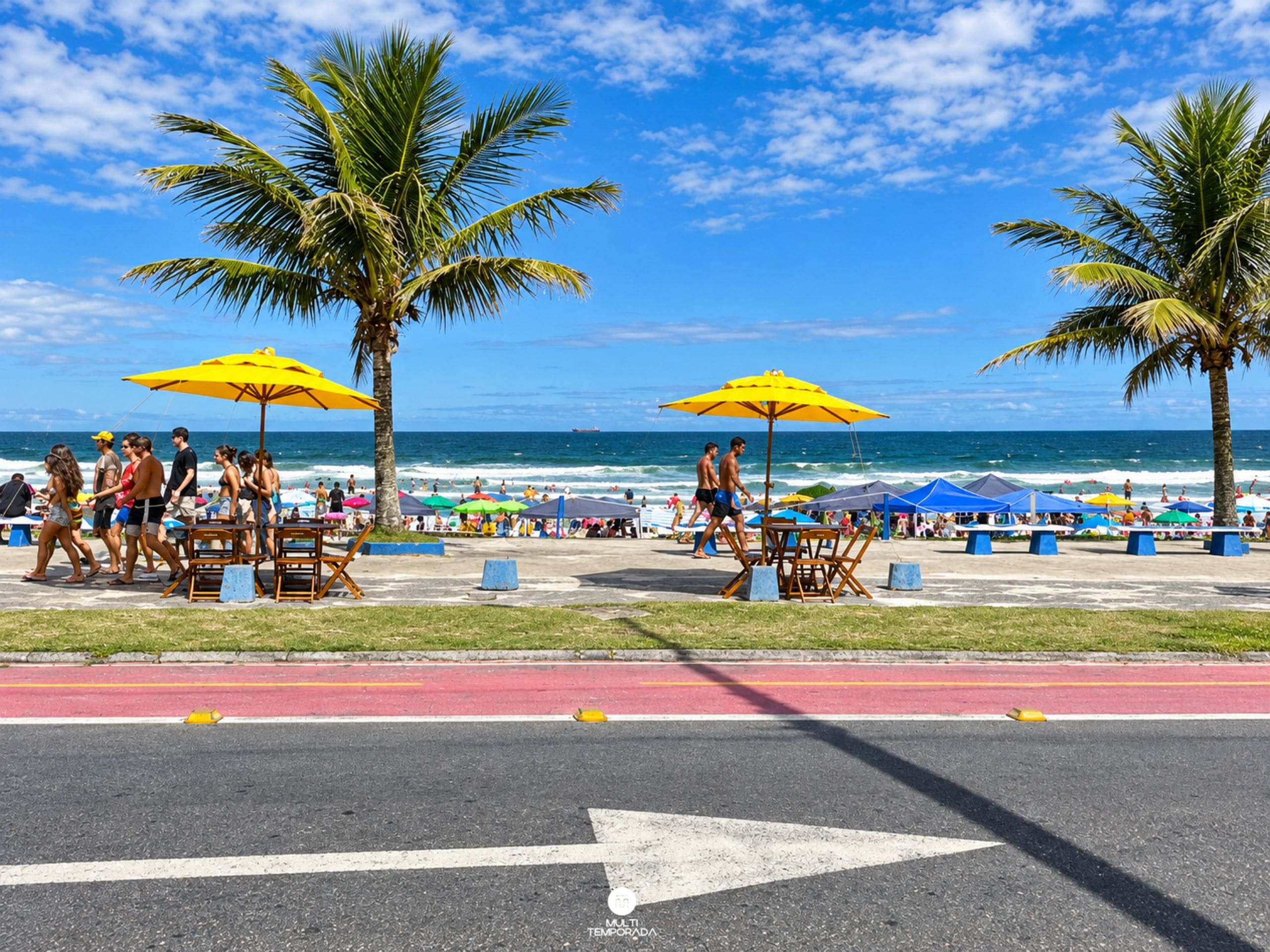 A beachside promenade with palm trees, beach umbrellas, and people walking.