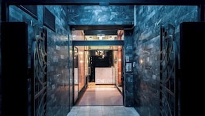 A modern hotel entrance with a glass door and a sign that reads "ONE LUXURY". - One Luxury Suites (Belgrade)