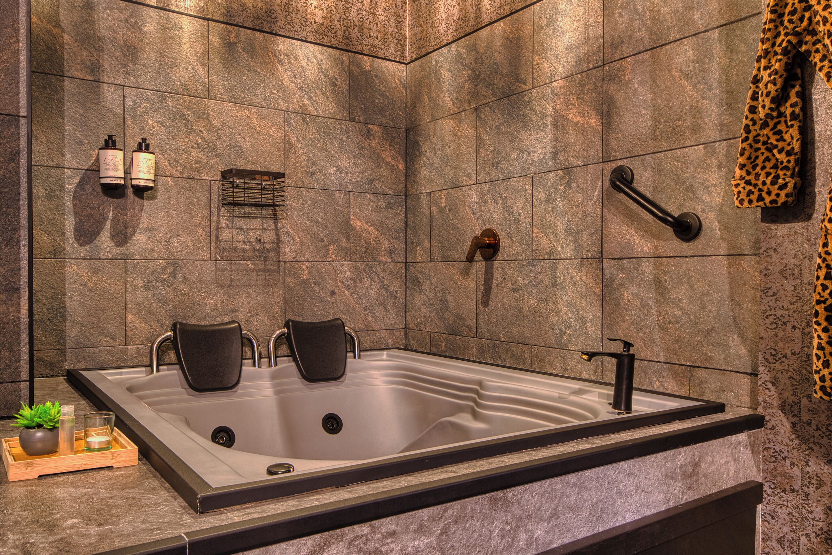 A modern bathroom with a large bathtub, a shower, and a towel rack.