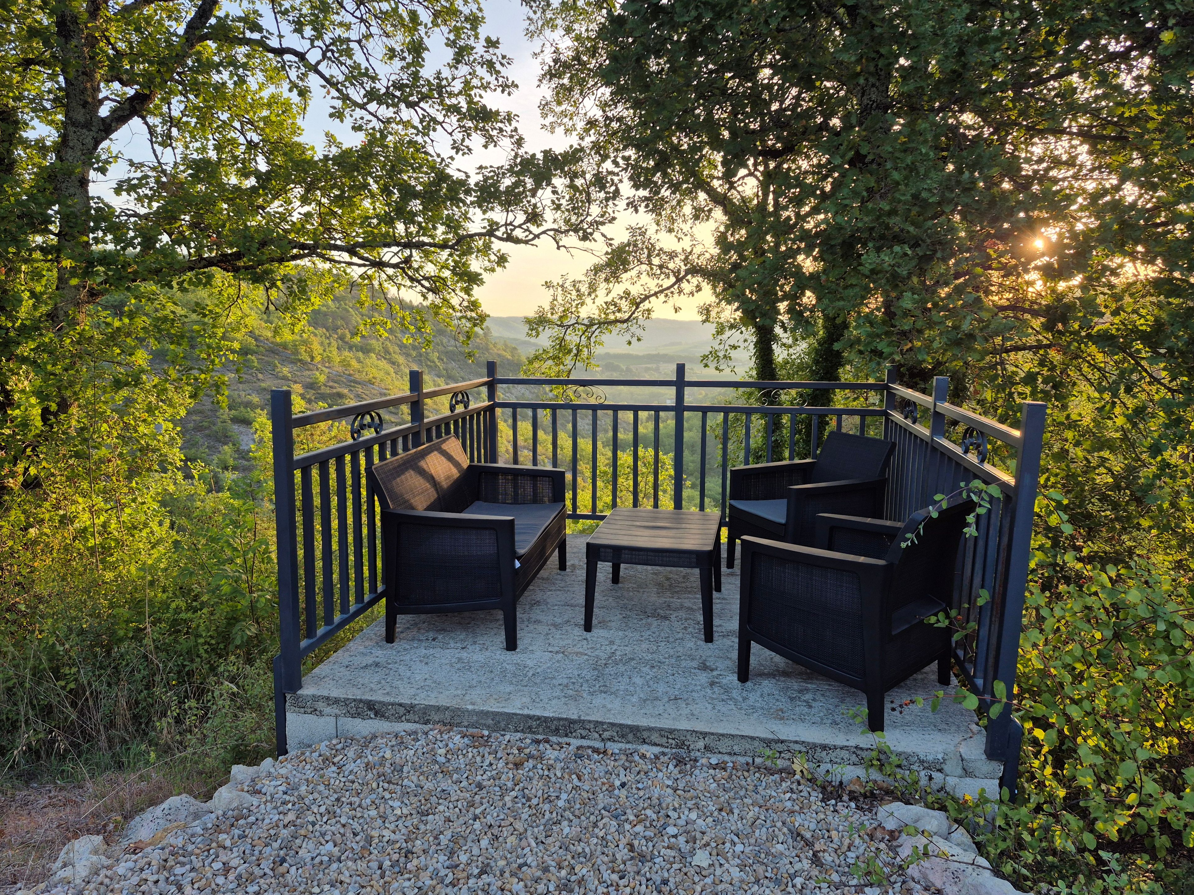 An outdoor seating area with a view of a mountainous landscape.