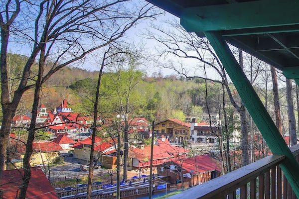 Unwind on the covered balcony as you take in the charming Bavarian-style village below, where vibrant rooftops and mountain views create the perfect backdrop for a peaceful escape.