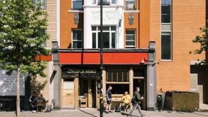 A two-story building with a brick facade and a large arched window. - Modern King's Cross Studio 004 (London)