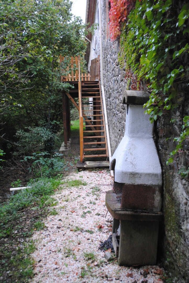 A narrow stone pathway leading to a wooden staircase.