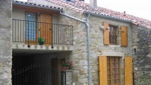 A two-story stone building with wooden shutters, a balcony, and a small garden area. - La Bergerie - DIO-ET-VALQUIERES (DIO-ET-VALQUIERES)