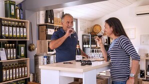A wine tasting room with shelves of wine bottles, a tasting table with glasses, and a wine bottle labeled "Saint Martin".