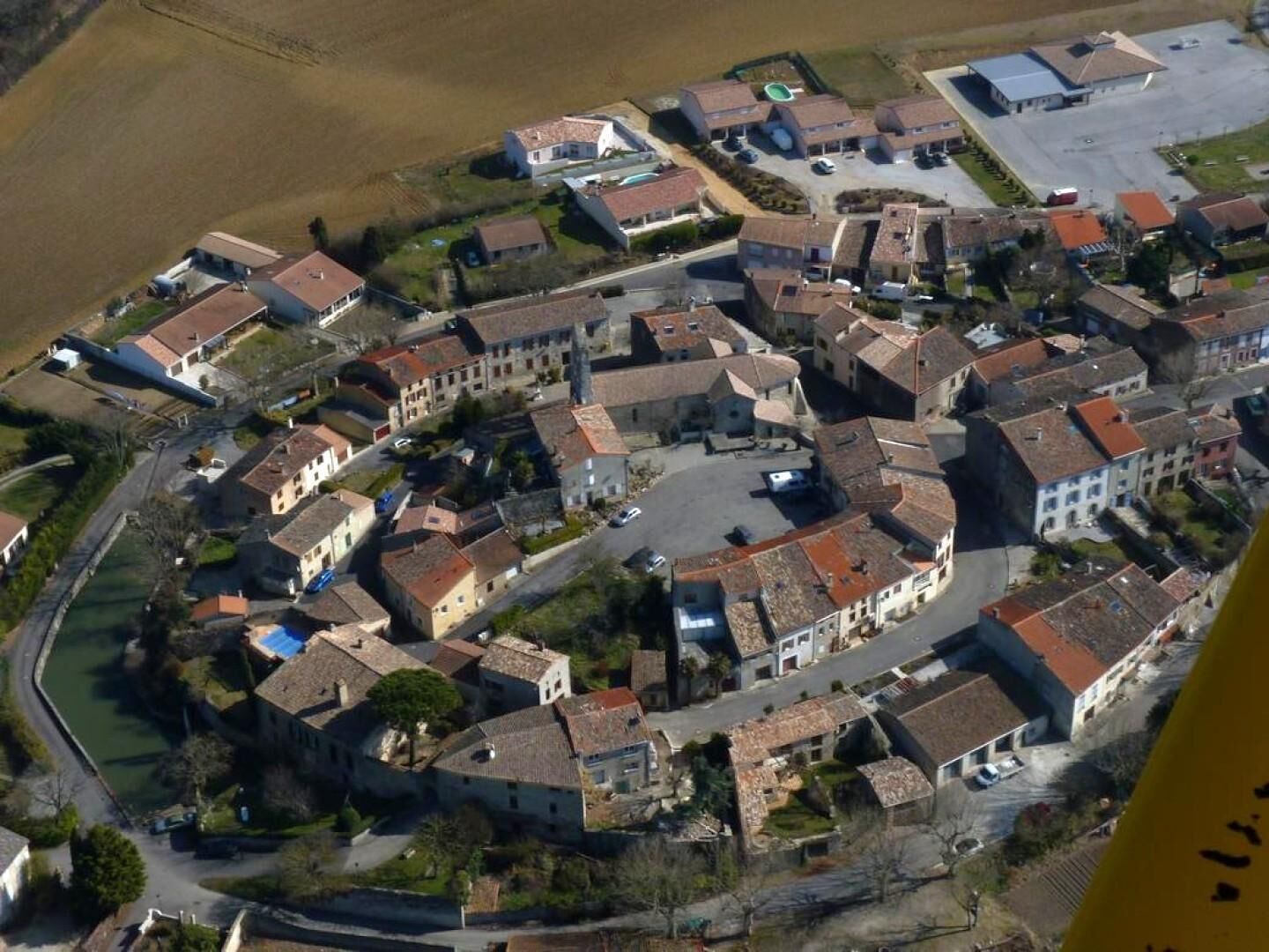 A small town with closely packed buildings, narrow streets, and a central square.