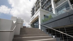 A modern building with a staircase leading to a ground floor entrance. - Key West 417 by Ctha (Milnerton)
