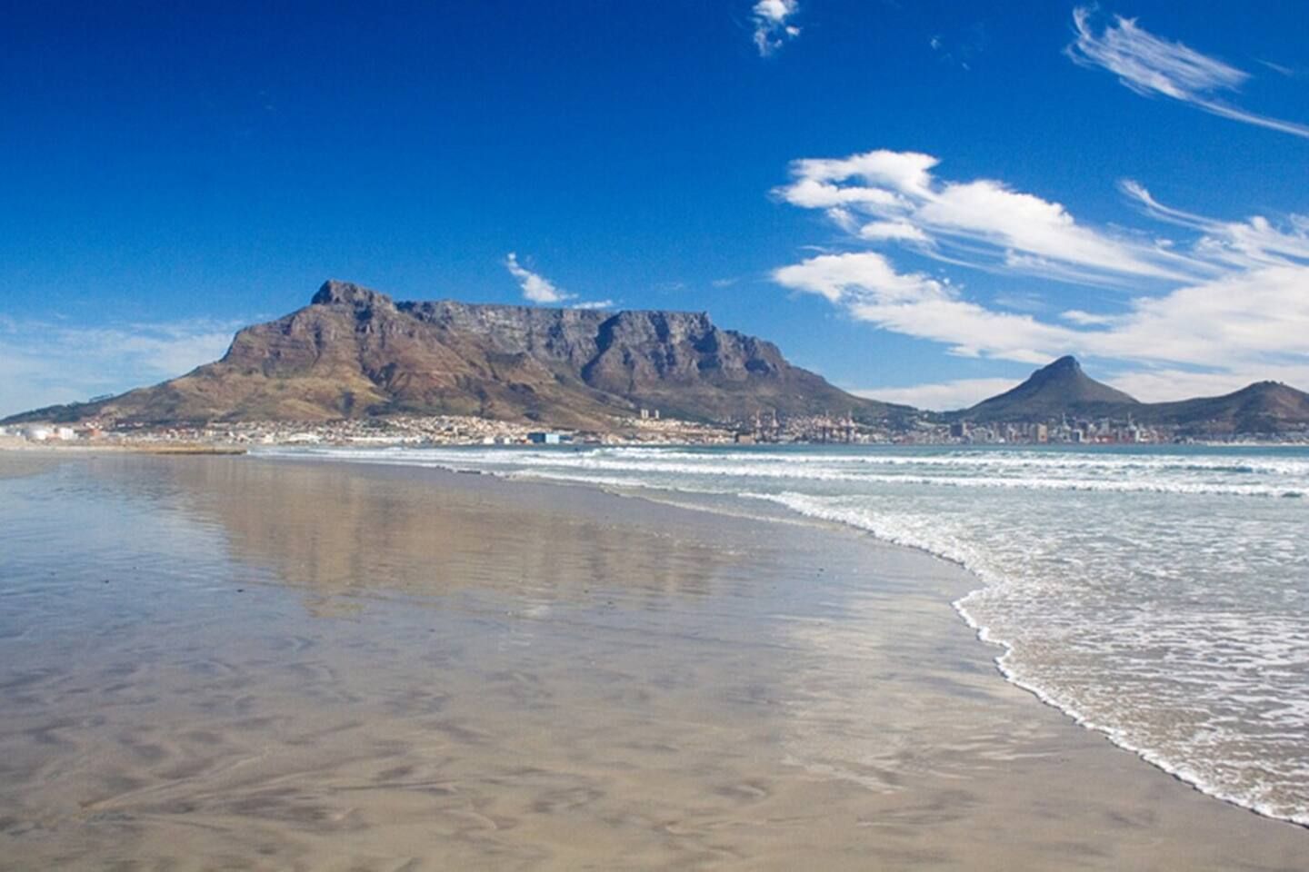 A beach with a mountain in the background.