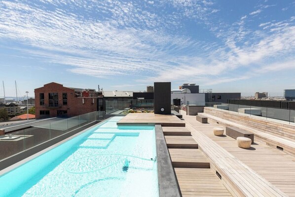 A rooftop pool with a clear view of the city skyline.