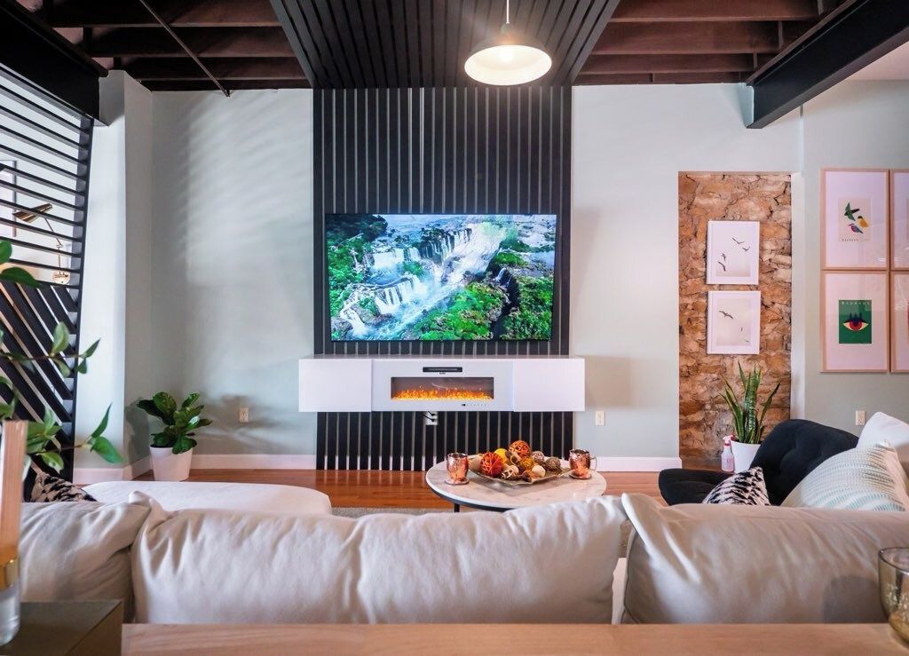 85-inch smart TV above an electric fireplace