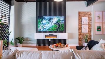 85-inch smart TV above an electric fireplace