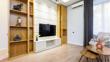 Comfort Apartment | Living area | 50-inch flat-screen TV with cable channels