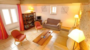 A living room with a sofa, two armchairs, a coffee table, a bookshelf, a television, and a lamp. - Les oliviers - THUIR (THUIR)