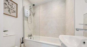 Shower, hair dryer, towels, shampoo