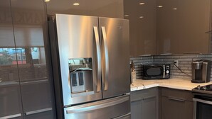 A modern kitchen with stainless steel appliances, a microwave, and a coffee maker. - STUNNING Views, SUBERB Location..NEW NEW NEW to The Racquet Club in Scottsdale! (Scottsdale)
