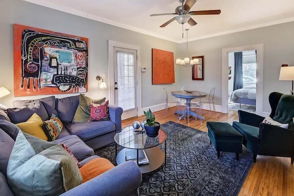 Relax in this inviting living space with comfortable seating, colorful accents, and plenty of natural light. The open layout connects seamlessly to the dining area, creating a warm and welcoming place to unwind.