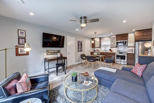 Sun-drenched living area featuring a large Smart TV and free Wi-Fi for your favorite streaming apps.