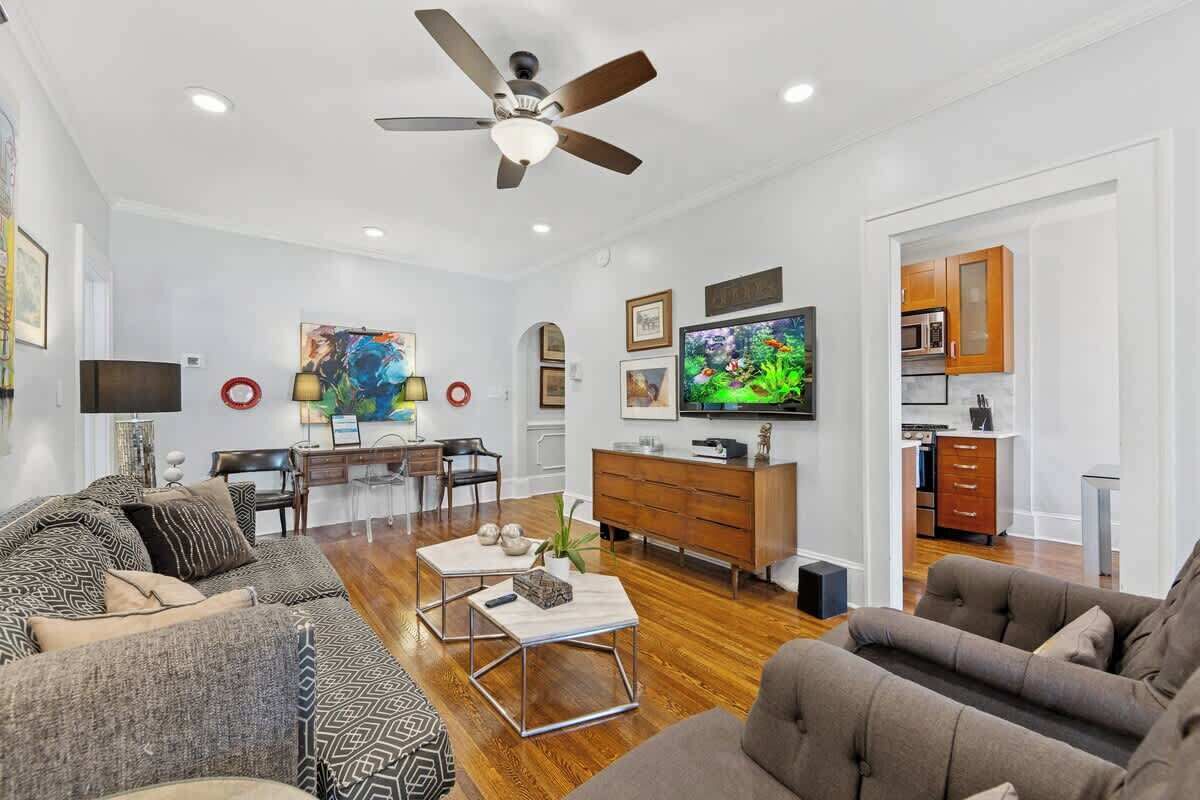 Spacious and inviting, this living area features comfortable seating, warm hardwood floors, and a smart TV for entertainment. A great space to relax or spend time together.
