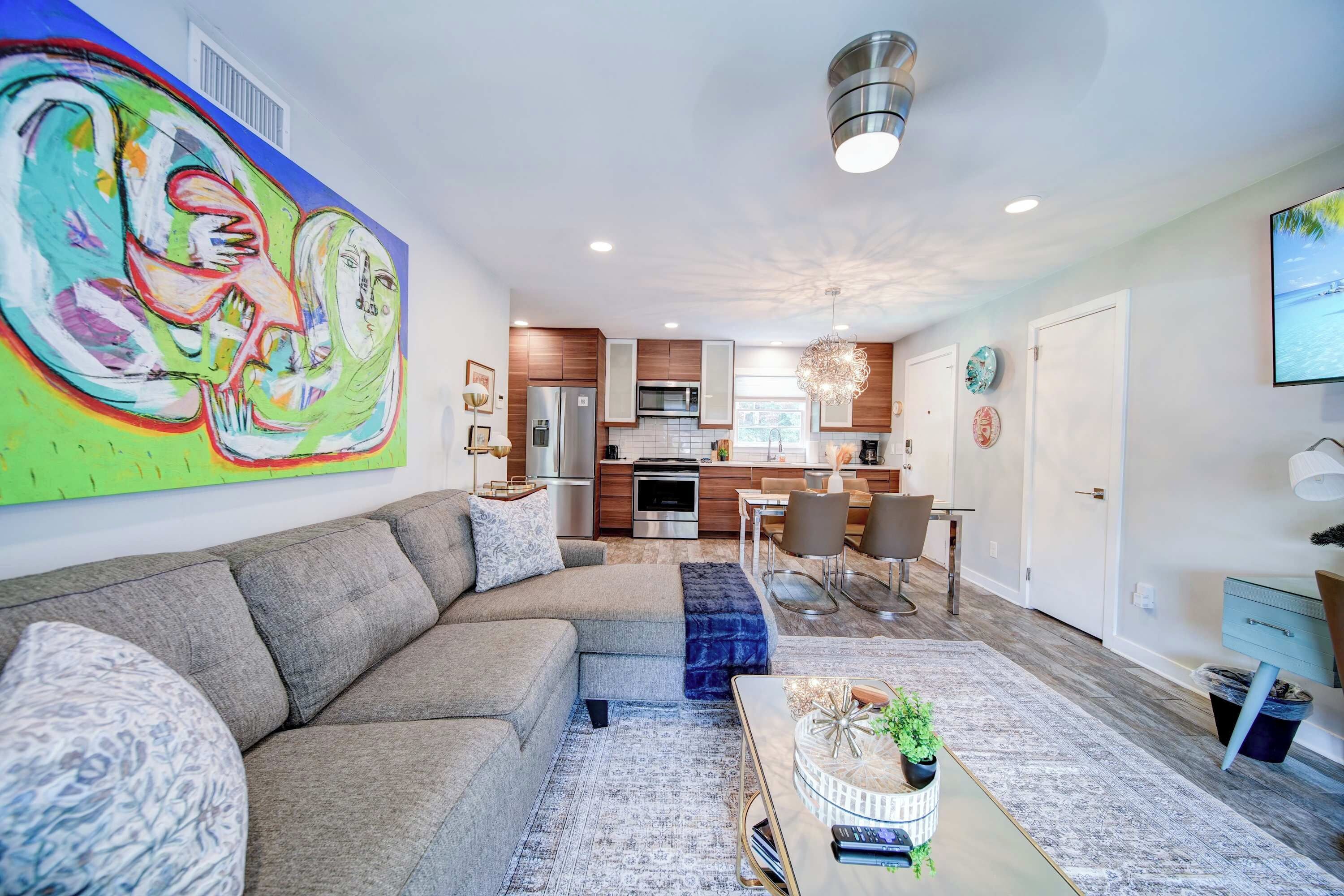 Stretch out on the roomy sectional and enjoy a bright living space filled with colorful artwork and natural light.