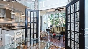 A spacious kitchen with modern appliances and a dining area with a glass table.