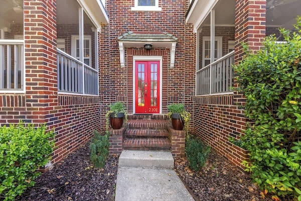 Classic brick exterior with a bold red door, adding charm and character to the home.
