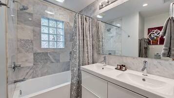 Shower, hair dryer, towels, shampoo