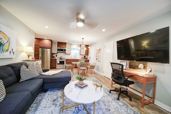 Settle into the spacious living room with a large TV and dedicated desk for working remotely.