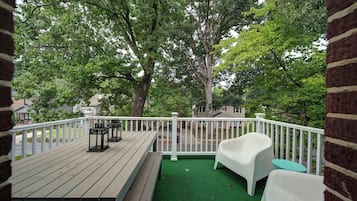 Enjoy peaceful, tree-lined Charlotte neighborhood views from the furnished outdoor balcony, a relaxing spot for morning coffee or evening downtime.
