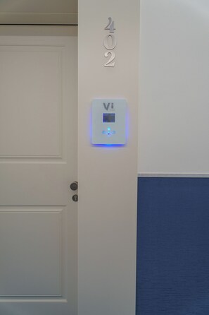 A door with a digital lock and a control panel with illuminated buttons. - Vi Place (Lido di Camaiore)