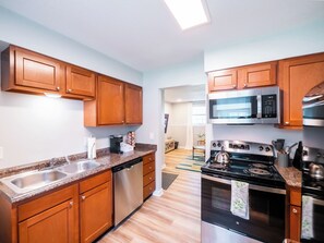 Kitchen with stainless appliances - Playful, walkable, and comfortable, just steps from Mass Street. (Lawrence)