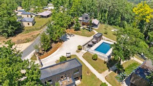A residential area with modern houses, a swimming pool, and a well-maintained lawn.