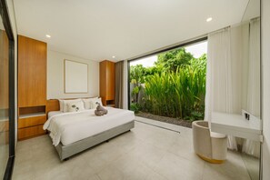 A modern bedroom with a large bed, a built-in wardrobe, a bedside table, and a view of a lush garden.