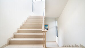 A staircase with a handrail, leading to a higher floor. - Rehat at Villa Golf Island Dago Resort I (Cimenyan)