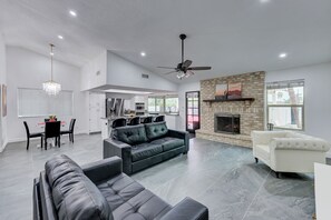 A spacious living area with a fireplace, a dining area, and a kitchen. - Phoenix, Pool, Hottub, basketball court, arcades, mountain views and much more! (Phoenix)