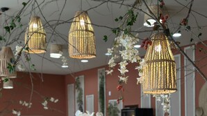 A well-lit bar area with hanging lights, a variety of food and drink options, and a rustic bamboo backdrop. - Oasis do Mar Hotel (Itapema)