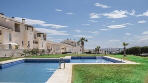 A residential building with a swimming pool and a grassy area. - Relaxation, Golf and Beach (Velez-Malaga)
